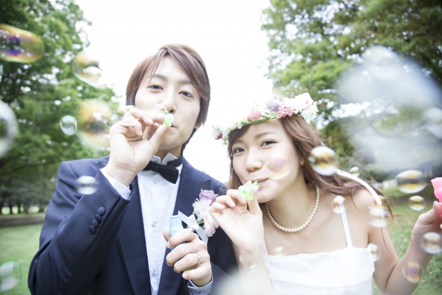 43795335 - bride and groom play with bubbles